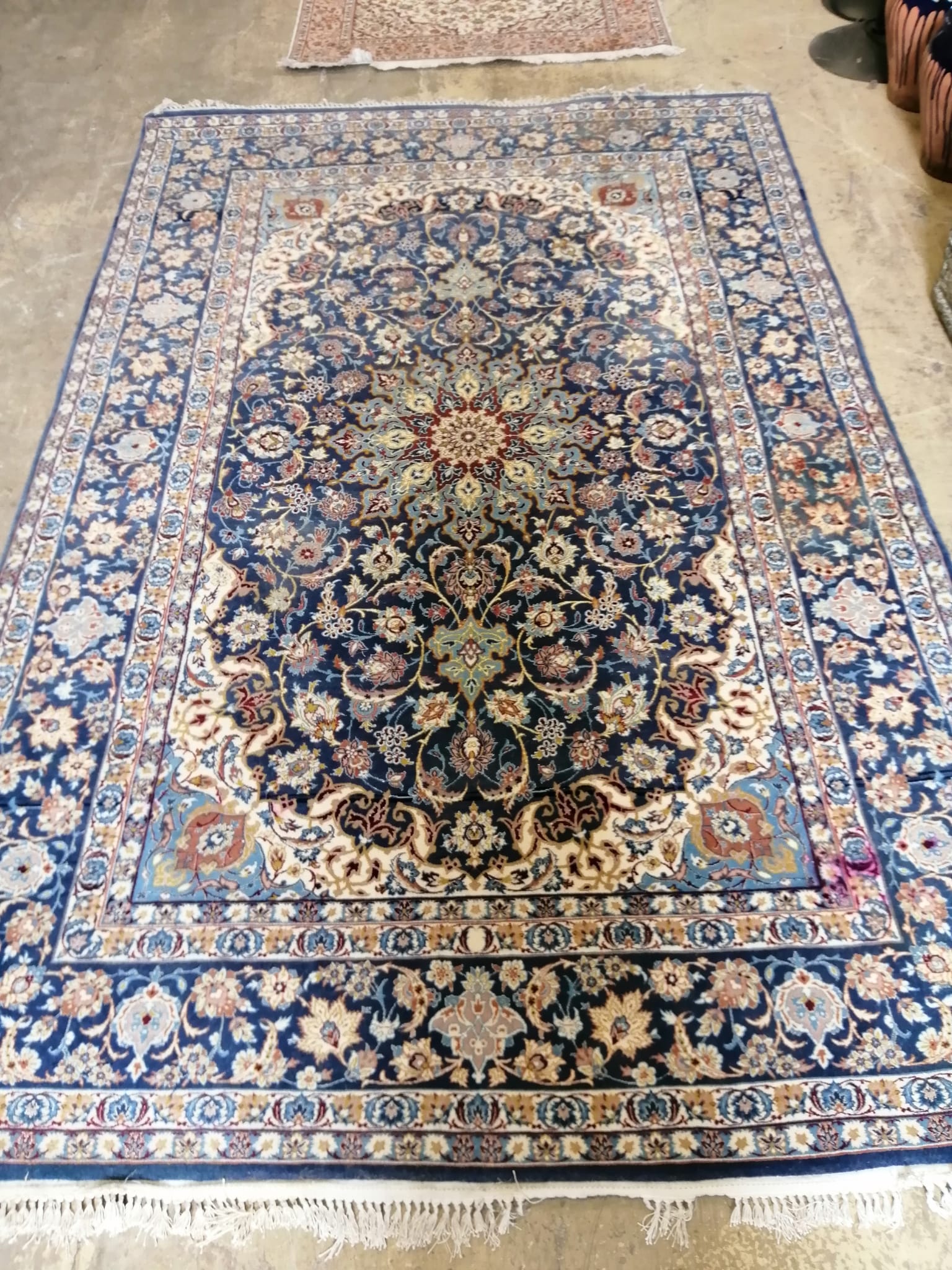 An Iranian silk blue ground carpet with central foliate motifs, 240 x 151cm